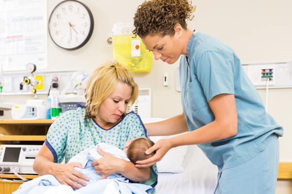 Nurse with a mother and a newborn